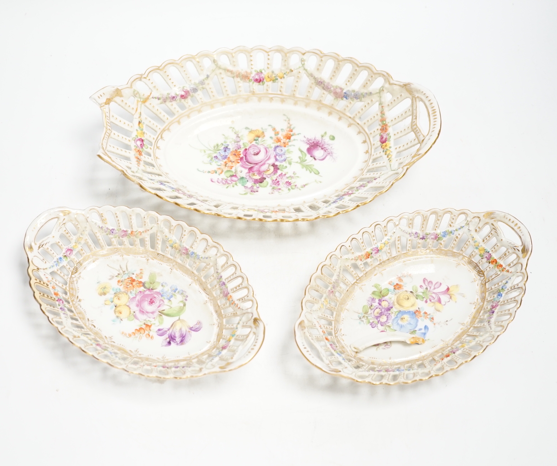 A trio of Dresden pierced floral painted porcelain oval baskets